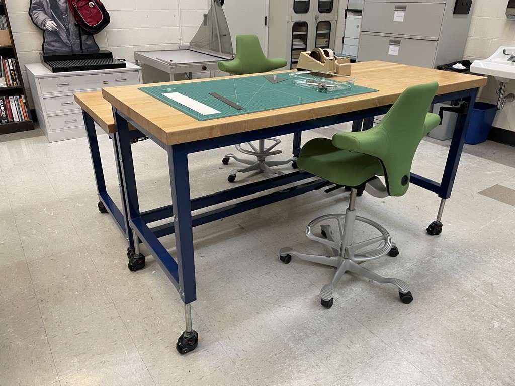 Image shows two conservation lab work tables at different heights.